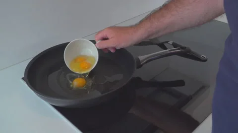 Man preparing eggs in kitchen Stock Footage 144952915