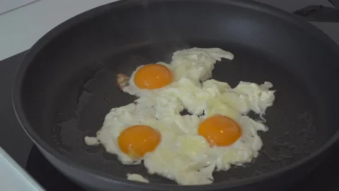 Man preparing eggs in kitchen Stock Footage 144954123