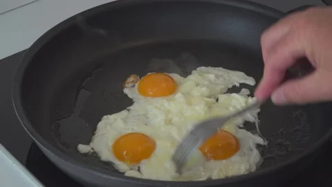 Man preparing eggs in kitchen Stock Footage 144954366