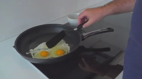 Man preparing eggs in kitchen Stock Footage 144954444