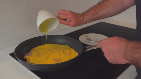 Man preparing eggs in kitchen Video stock 144955973