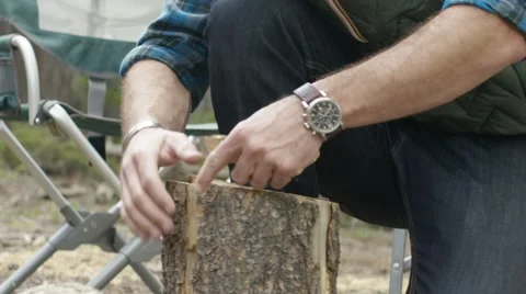 Man preparing firewood for bonfire Stock Footage 68493726