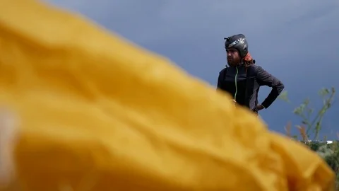 Man Is Preparing To Fly On A Paraglider With Parachute Background Stock Footage 77513316