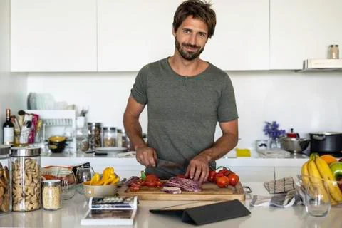 Man preparing food in kitchen Stock Photos