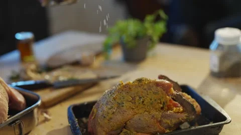 A man is preparing food on a table with a variety of meats and vegetables Stock Footage 295368885