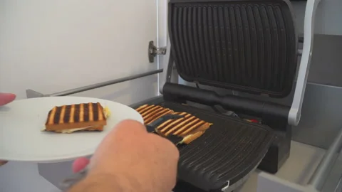 Man preparing fresh toast in toaster Stock Footage 145718009