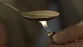 Man preparing heroin dose in spoon with lighter, drugs dependence, death risk HD Footage