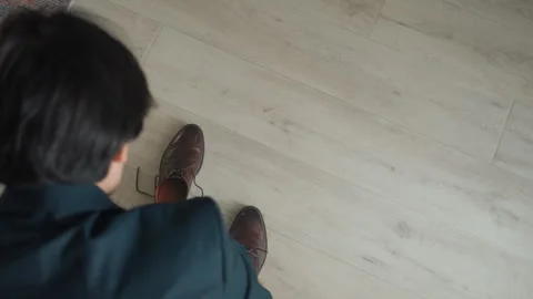 Man preparing his attire for formal engagement or work. An Asian man Stock Footage 342063738