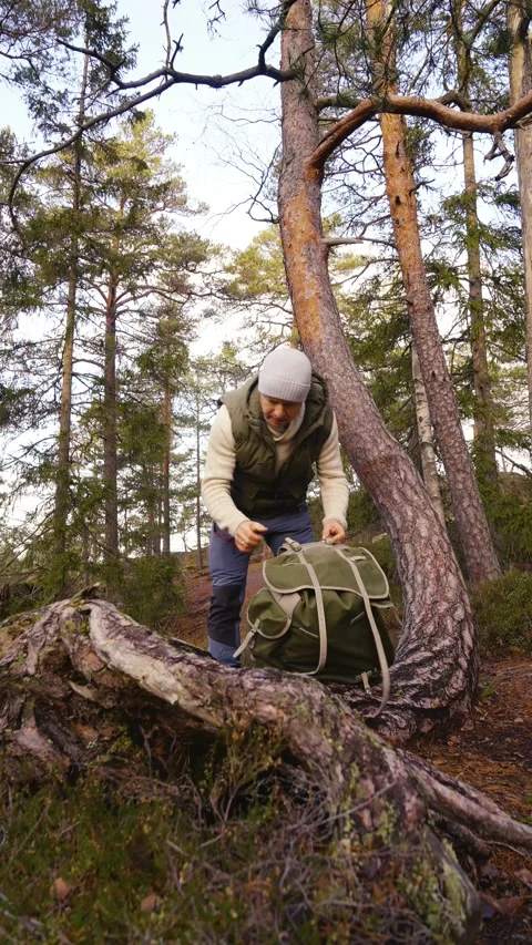 A man preparing his camera for photography in a forest. Stock Footage 303783043