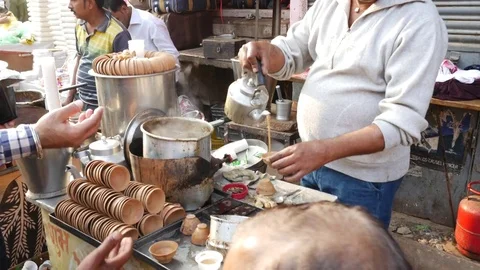 Man preparing Indian Masala tea chai latte in Varanasi Stock Footage 70106359
