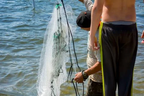 Man Preparing for Launching Fishnet Stock Photos