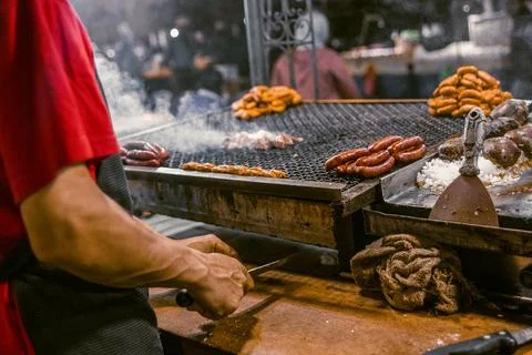 Man preparing meat on the griddle to make street food at the Beni Mellal. Stock Photos