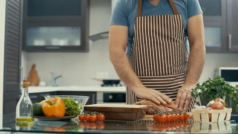 Man preparing meat in the kitchen . Stockbeeldmateriaal 85791856