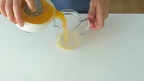 Man preparing orange juice in the kitchen Stock Footage 199209753