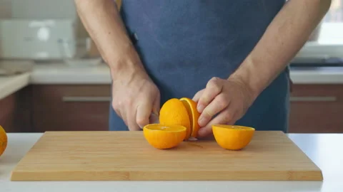 Man preparing orange juice in the kitchen Stock Footage 199211903