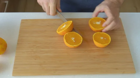 Man preparing orange juice in the kitchen Stock Footage 201589651