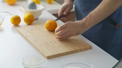 Man preparing orange juice in the kitchen Stock Footage 219677107