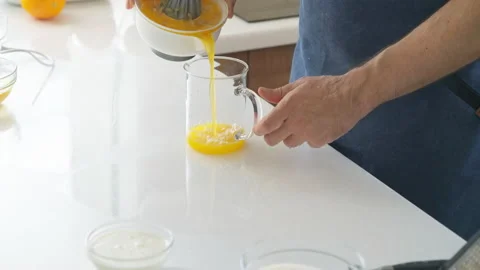 Man preparing orange juice in the kitchen Stock Footage 219677229