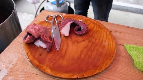 Man preparing a portion of octopus a feira, a traditional Galician dish. Spain. Stock Footage 122987862