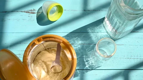 Man preparing powdered milk for kid in a sunny morning Stock Footage 132934264