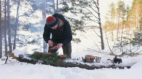 Man is preparing quail in winter forest Stock Footage 170461617