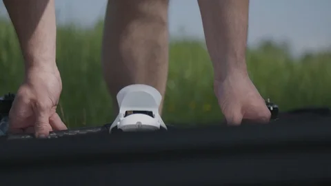 Man is preparing a remote control drone to fly Stockbeeldmateriaal 94604223