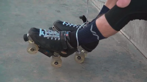 Man Preparing For Roller Skating, Putting On Rollerskates Stock Footage 105424966