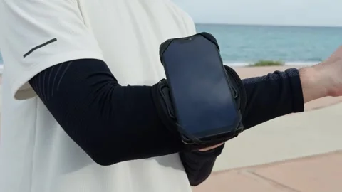 Man Preparing To Run And Securing The Phone At The Arm Video stock 275819074