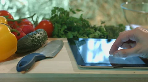 Man preparing salad vegetable dish and writes a prescription for a tablet comput Stock Footage 62837977