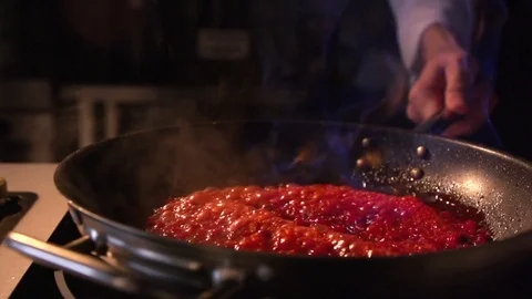 A man is preparing a sauce in a frying pan. Slowly pouring oil. Slow motion Stock Footage 73866826