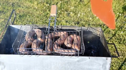 Man preparing sausages on the grill Stock Footage 243769222