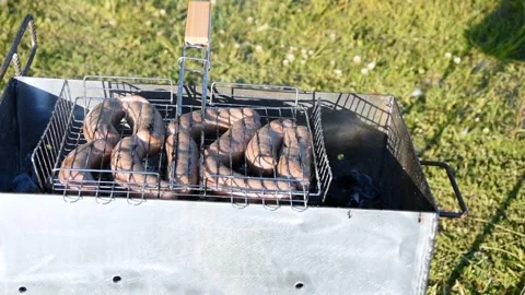 Man preparing sausages on the grill Stock Footage 243769255