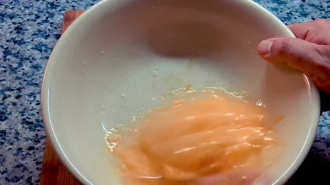 A man is preparing scrambled eggs. Stock Footage 209947661