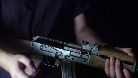 Man preparing to shoot with a rifle in slow motion Stock Footage 81230612