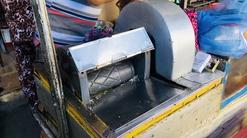 Man preparing sugarcane fresh juice in press machine Stock Footage 123633237