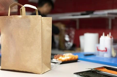 Man preparing sushi order takeaway Stock Photos