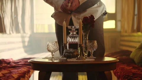 A man preparing the table for a date and lighting candles Vídeo Stock 259591528