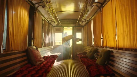 A man preparing the table for a date in an old tram Stock Footage 259594374