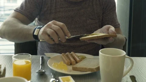 Man preparing tasty sandwich, breakfast by table in cafe Stock Footage 159065298