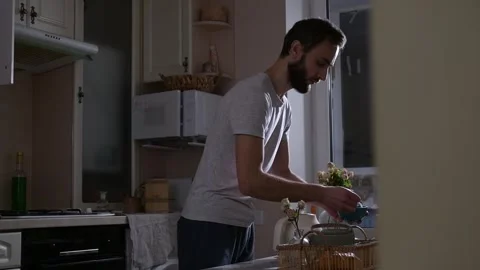 Man preparing tea for breakfast in bed, adding sugar into a teapot 库存影片 330128673