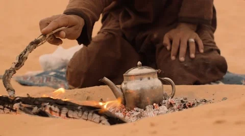 Man preparing tea in the desert, close up Stock Footage 58594865