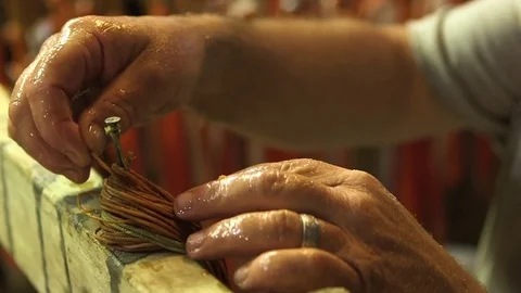 Man preparing a thread to tie the fish fillets 스톡 동영상 83179773