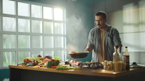 Man preparing vegetables in wok Stock Footage 311834994