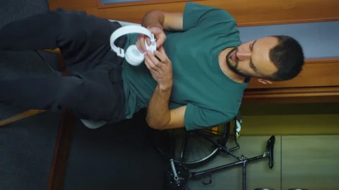 Man preparing wireless headphones to listen to music. Bearded caucasian man at Stock Footage 166062543
