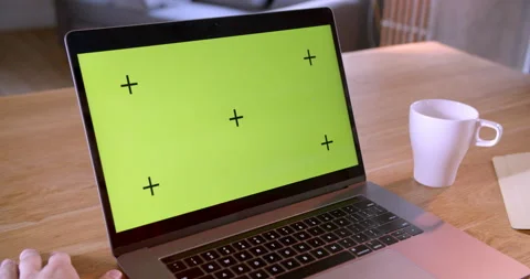 Man preparing working with chroma key green screen laptop, showing big finger Stock Footage 170634950