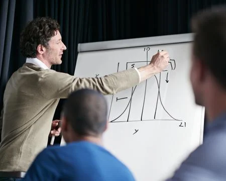 Man, presentation and chart data on whiteboard, board and group of business Stock Photos