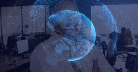 Man presenting in computer lab, globe rotating causing face clearing while Stock Footage 330540794