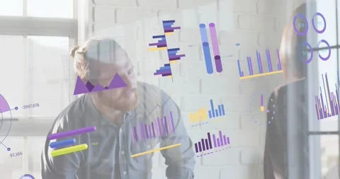 Man presenting data with peer in office and animating floating charts explaining Stock Footage 318142343