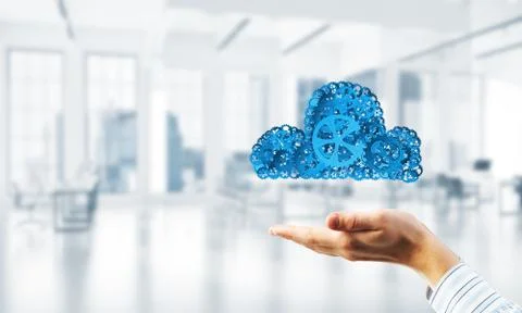 Man presenting in his palms cloud computing concept as mechanism of cogwheels 스톡 사진