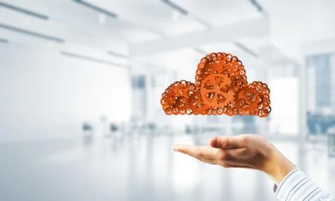 Man presenting in his palms cloud computing concept as mechanism of cogwheels 写真素材